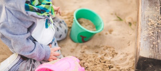 little boy playing in the sand